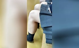 A close-up view of a JK-style beauty in a uniform with a miniskirt that